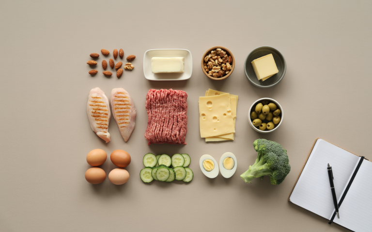 keto ingredients flatlay with notebook symbolizing long term planning