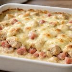 A creamy low-carb chicken bake with layers of seasoned chicken, diced ham, and melted Swiss cheese covered in a smooth Dijon cream sauce.