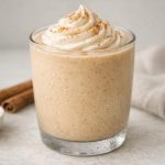 A thick, creamy smoothie with cinnamon and vanilla flavors, blended with protein for a smooth, drinkable texture.