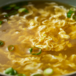 Light savory broth with soft egg ribbons and green onion.
